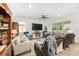 Spacious living room with ample seating, a large TV, and natural light from the windows at 8989 Sw 57Th Place Rd, Ocala, FL 34481