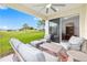 Enjoy the outdoor patio with comfortable seating and views of the lush green lawn and palm trees at 8989 Sw 57Th Place Rd, Ocala, FL 34481