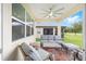 Relax on this covered patio with ceiling fan and a view of the green backyard and golf course at 8989 Sw 57Th Place Rd, Ocala, FL 34481