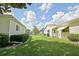 Manicured backyard features lush green grass and well-maintained property in a quiet neighborhood at 9486 Se 173Rd Pl, Summerfield, FL 34491