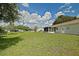 Expansive backyard featuring lush green grass and screened-in lanai for outdoor enjoyment at 9486 Se 173Rd Pl, Summerfield, FL 34491