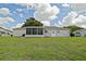 Charming home featuring a screened-in lanai and well-maintained yard, ideal for comfortable outdoor living at 9486 Se 173Rd Pl, Summerfield, FL 34491