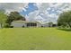 Well-maintained backyard featuring lush green grass, screened-in lanai, perfect for outdoor enjoyment at 9486 Se 173Rd Pl, Summerfield, FL 34491