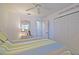Bedroom featuring a ceiling fan, closet, and a bed with a blue and yellow striped comforter at 9486 Se 173Rd Pl, Summerfield, FL 34491