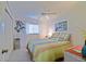 Bedroom with a ceiling fan, closet, window and a bed with a colorful striped comforter at 9486 Se 173Rd Pl, Summerfield, FL 34491
