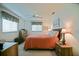 Comfortable bedroom featuring a cozy bed, ceiling fan, natural light, and coastal decor at 9486 Se 173Rd Pl, Summerfield, FL 34491
