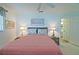 Bedroom featuring a large bed, lamps, coastal decor, and a view into the bathroom at 9486 Se 173Rd Pl, Summerfield, FL 34491
