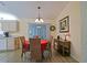 Cozy dining area with a table, four chairs, and access to the screened-in lanai at 9486 Se 173Rd Pl, Summerfield, FL 34491