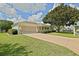 Charming single-story home featuring a spacious driveway and well-maintained landscaping at 9486 Se 173Rd Pl, Summerfield, FL 34491