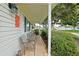 Inviting front porch with seating, offering a relaxing outdoor space at 9486 Se 173Rd Pl, Summerfield, FL 34491