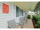 Comfortable front porch with seating, ideal for enjoying the neighborhood views at 9486 Se 173Rd Pl, Summerfield, FL 34491
