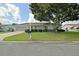 Charming single-story home with well-maintained lawn, mature tree, and inviting curb appeal at 9486 Se 173Rd Pl, Summerfield, FL 34491