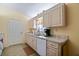 Well-lit kitchen featuring wood cabinets, appliances, and light countertops, adjacent to a door to the lanai at 9486 Se 173Rd Pl, Summerfield, FL 34491