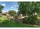 Beautifully landscaped backyard with a water feature, and mature trees at 9805 Sw 95Th Loop, Ocala, FL 34481