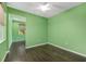 Bedroom with hardwood floors, green walls, and large windows at 9805 Sw 95Th Loop, Ocala, FL 34481