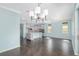 Open concept living space with a modern chandelier, and views into the kitchen at 9805 Sw 95Th Loop, Ocala, FL 34481