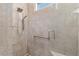Modern tiled shower featuring a grab bar, and a rainfall shower head at 9805 Sw 95Th Loop, Ocala, FL 34481