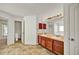 Bathroom featuring double vanity, tile floor, and separate toilet room at 9952 Sw 58Th Ave, Ocala, FL 34476