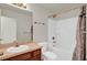 Bright bathroom featuring a tub, shower combo, vanity, and bronze fixtures at 9952 Sw 58Th Ave, Ocala, FL 34476