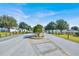 Community entrance with landscaping, signage, and well-maintained roads at 9952 Sw 58Th Ave, Ocala, FL 34476