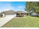 Charming single-story home with a well-maintained lawn and attached two-car garage at 9952 Sw 58Th Ave, Ocala, FL 34476