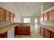 Open kitchen features wooden cabinets, laminate countertops, and tile flooring at 9952 Sw 58Th Ave, Ocala, FL 34476