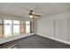 Bright sunroom featuring vertical blinds, carpet, and multiple windows at 9952 Sw 58Th Ave, Ocala, FL 34476
