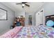 Bright bedroom featuring a wood desk area and walk-in closet at 10210 Sw 93Rd Ave, Ocala, FL 34481