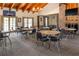 A community room with tables, chairs, a brick fireplace, and a large screen TV at 10210 Sw 93Rd Ave, Ocala, FL 34481