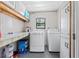Functional laundry room with washer, dryer, storage cabinets, and counter space at 10210 Sw 93Rd Ave, Ocala, FL 34481