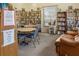 A cozy library featuring bookshelves, tables, chairs, and comfortable seating at 10210 Sw 93Rd Ave, Ocala, FL 34481