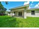Covered back porch and backyard area with green grass at 10675 Sw 69Th Ter, Ocala, FL 34476
