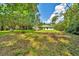 View of rear exterior elevation and wooded backyard at 10675 Sw 69Th Ter, Ocala, FL 34476