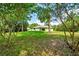 View of rear exterior elevation and wooded backyard at 10675 Sw 69Th Ter, Ocala, FL 34476