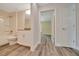 Bathroom and bedroom area with vinyl floors, neutral walls, and a tub-shower combination at 10675 Sw 69Th Ter, Ocala, FL 34476