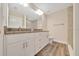 Bathroom with double sink vanity, stone countertop, and decorative lighting at 10675 Sw 69Th Ter, Ocala, FL 34476