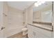 Bathroom with a granite countertop, single sink vanity, shower and bathtub combination at 10675 Sw 69Th Ter, Ocala, FL 34476