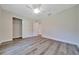Light filled bedroom features modern ceiling fan and a sliding door closet at 10675 Sw 69Th Ter, Ocala, FL 34476