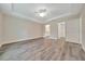 Large bright bedroom with tray ceiling, ceiling fan, luxury vinyl plank flooring, and ensuite bathroom at 10675 Sw 69Th Ter, Ocala, FL 34476