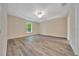 Bright, spacious bedroom with tray ceiling, ceiling fan, and large window at 10675 Sw 69Th Ter, Ocala, FL 34476