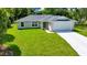 Charming single-story home featuring a well-manicured lawn and a two car garage at 10675 Sw 69Th Ter, Ocala, FL 34476
