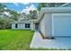 Charming single-story home featuring a well-manicured lawn and a two car garage at 10675 Sw 69Th Ter, Ocala, FL 34476