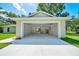 Two car garage with a modern garage door and ample room for cars or storage at 10675 Sw 69Th Ter, Ocala, FL 34476