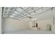 Interior view of a spacious two-car garage with modern utilities and concrete floor at 10675 Sw 69Th Ter, Ocala, FL 34476