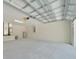 Interior view of a spacious two-car garage with modern utilities and concrete floor at 10675 Sw 69Th Ter, Ocala, FL 34476