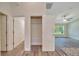 Hallway featuring a storage closet with wire shelving and doorway to the living area at 10675 Sw 69Th Ter, Ocala, FL 34476