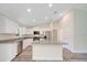 Spacious kitchen with white cabinets, stainless steel appliances, and center island with granite countertops at 10675 Sw 69Th Ter, Ocala, FL 34476