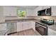 Updated kitchen featuring white cabinets, granite countertops, and stainless steel appliances at 10675 Sw 69Th Ter, Ocala, FL 34476