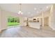 Open concept kitchen with stainless steel appliances, white cabinetry and a large island at 10675 Sw 69Th Ter, Ocala, FL 34476