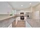 Updated kitchen featuring white cabinets, stainless steel appliances, and granite countertops at 10675 Sw 69Th Ter, Ocala, FL 34476